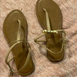 Tan and light pink sandals with gold bow